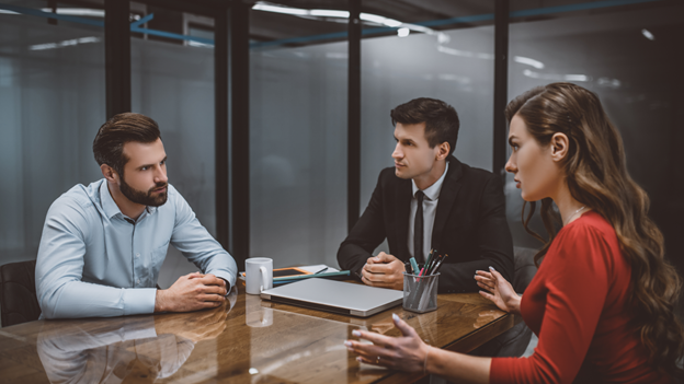 a couple discussing divorce with a lawyer at a table