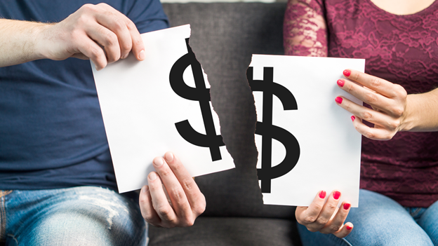 two people ripping out a piece of paper with a dollar sign on it