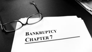 bankruptcy Chapter 7 documents with glasses on top