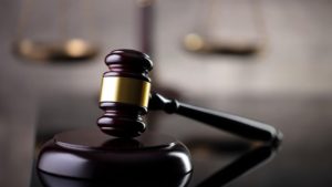 a gavel sits against a blurred background