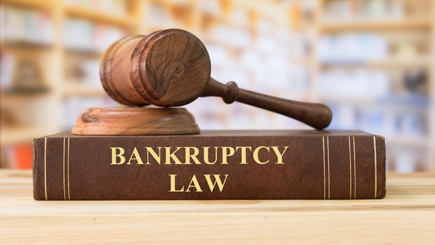 a gavel sits on top of a bankruptcy law book