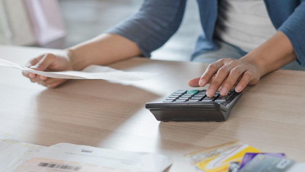 a person types on a calculator