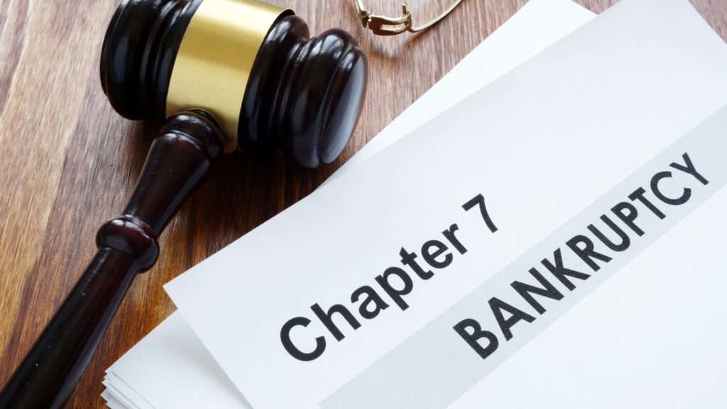 a Chapter 7 Bankruptcy paper sits next to a gavel