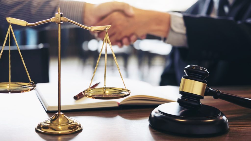 a lawyer shakes hands with a client