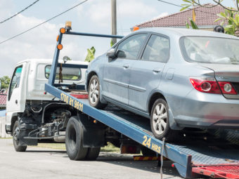 Car on a tow truck being repossessed | Texas bankruptcy lawyers