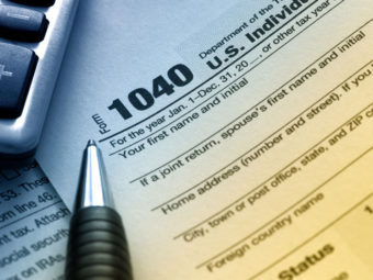 Form 1040 document with a pen | Texas bankruptcy lawyers