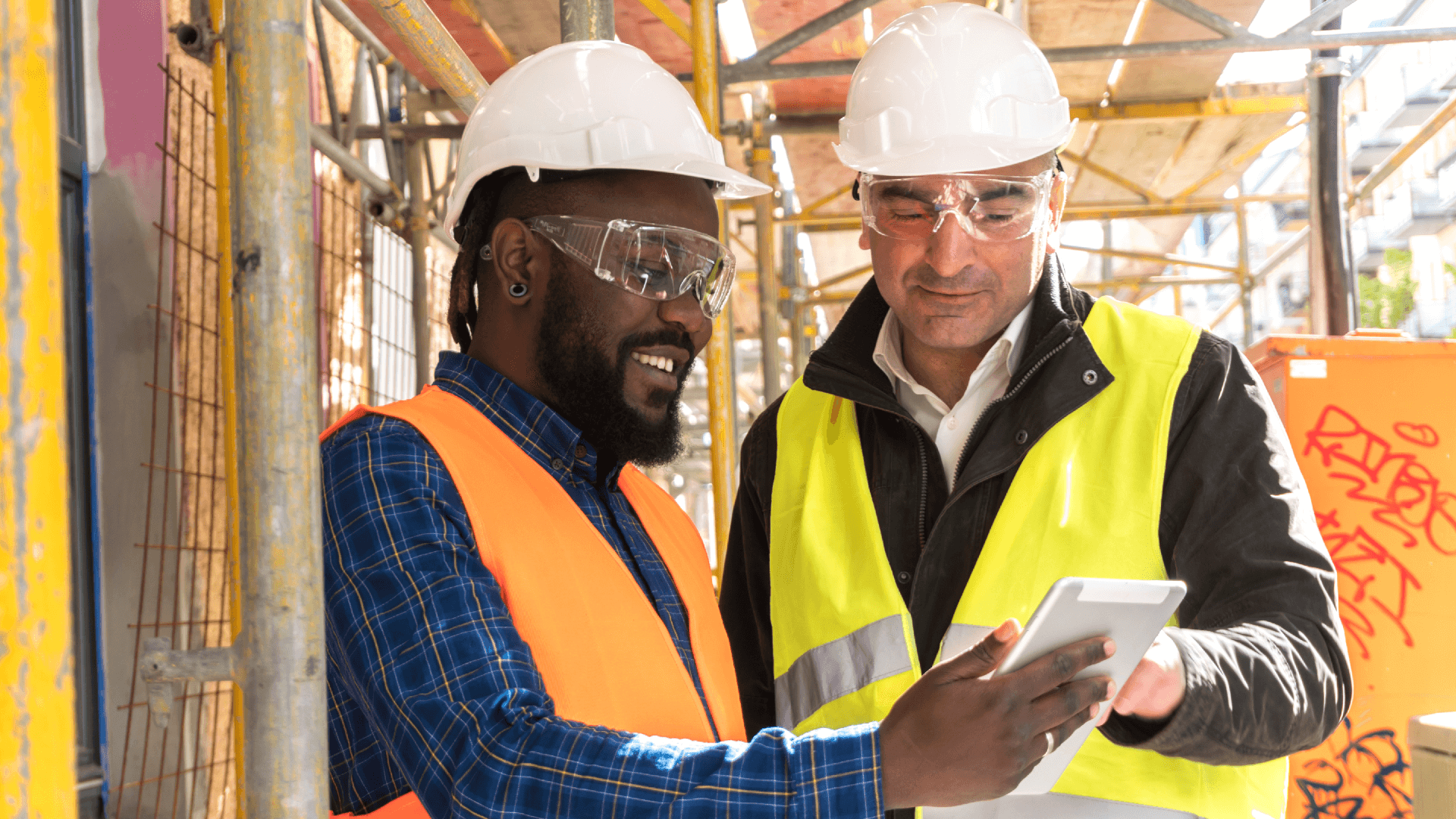 construction workers looking at tablet