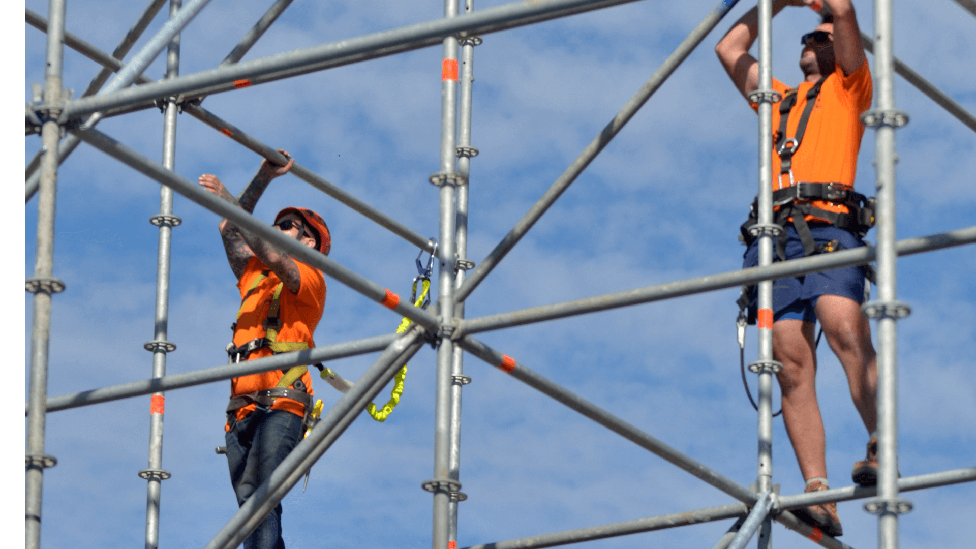two construction workers working on scaffolding