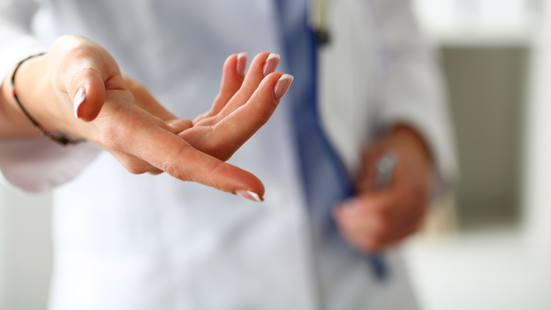 A doctor’s hand reaching out