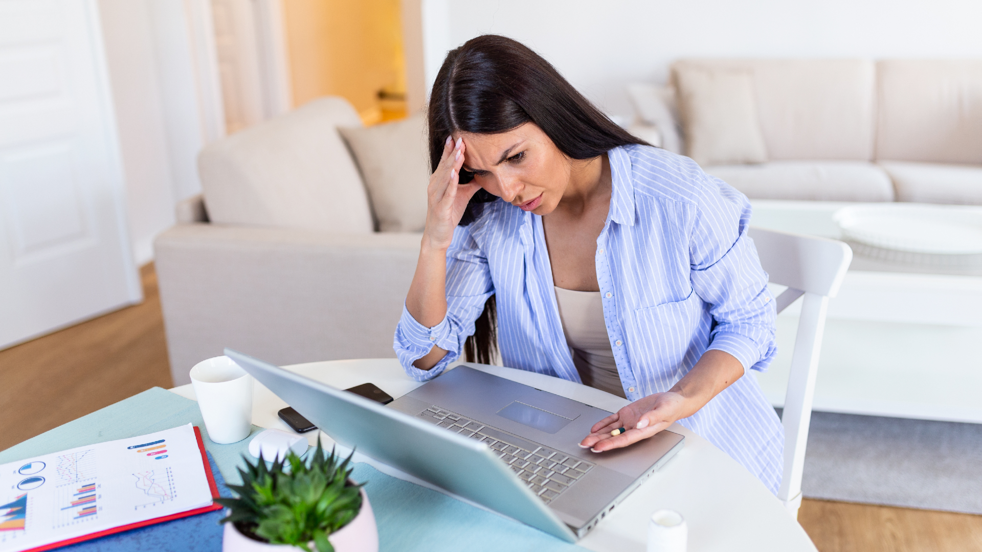 A frustrated woman looks at her laptop computer screen