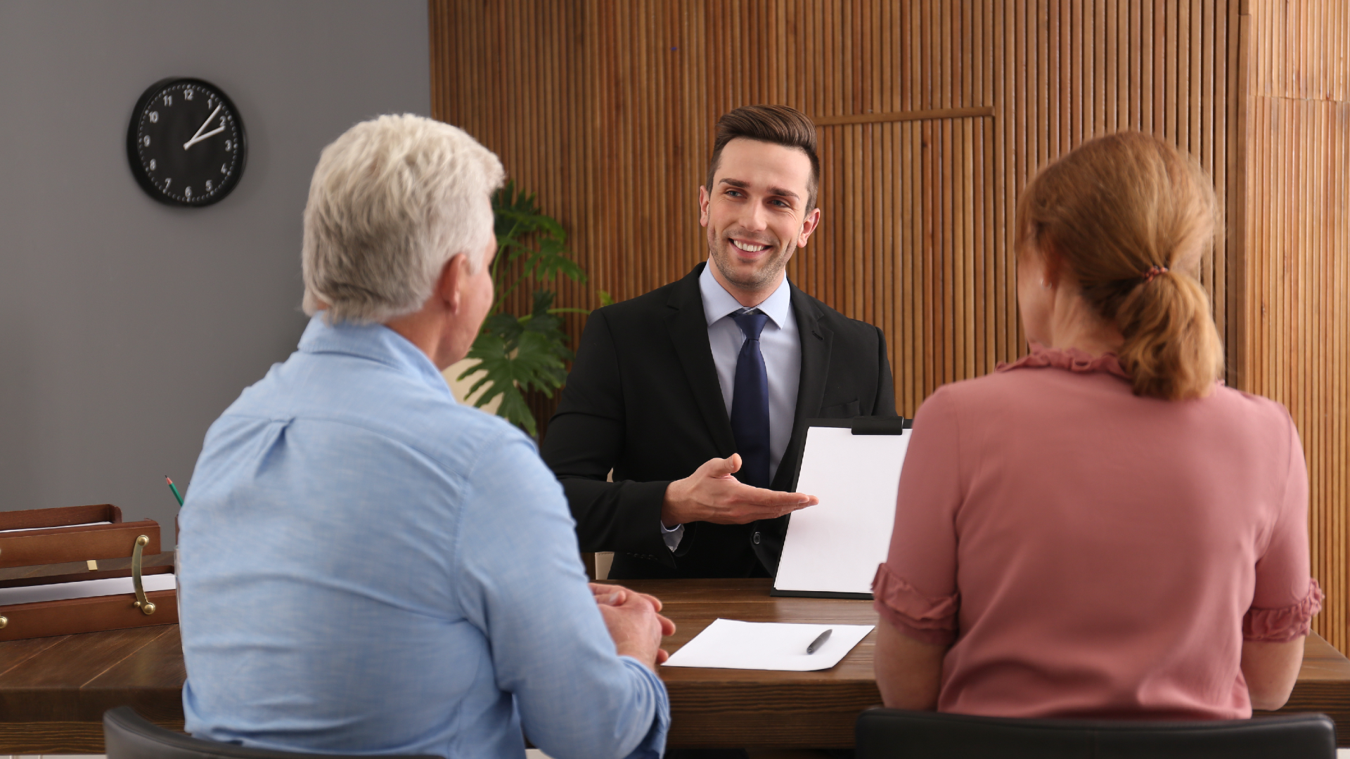 A lawyer presenting paperwork to a couple