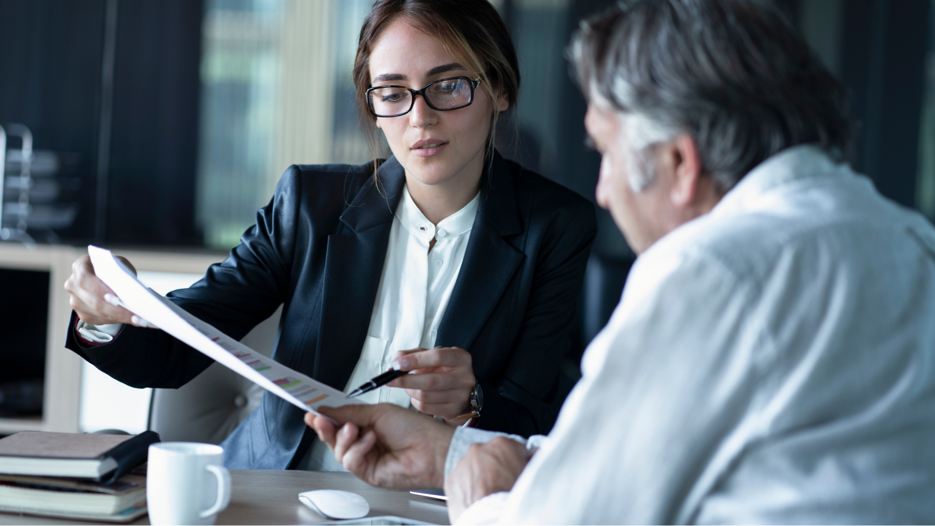 A lawyer reviewing paperwork with her client