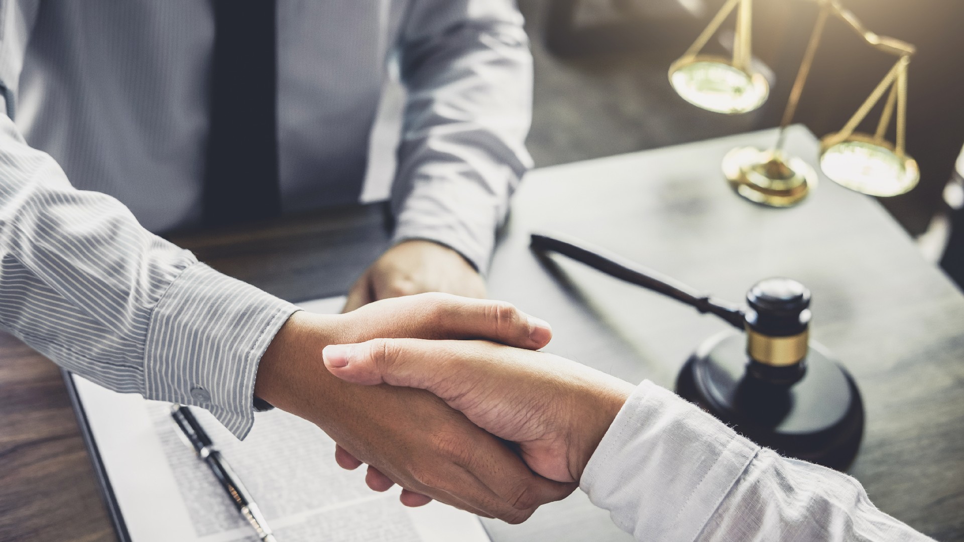 A lawyer shakes hands with a client