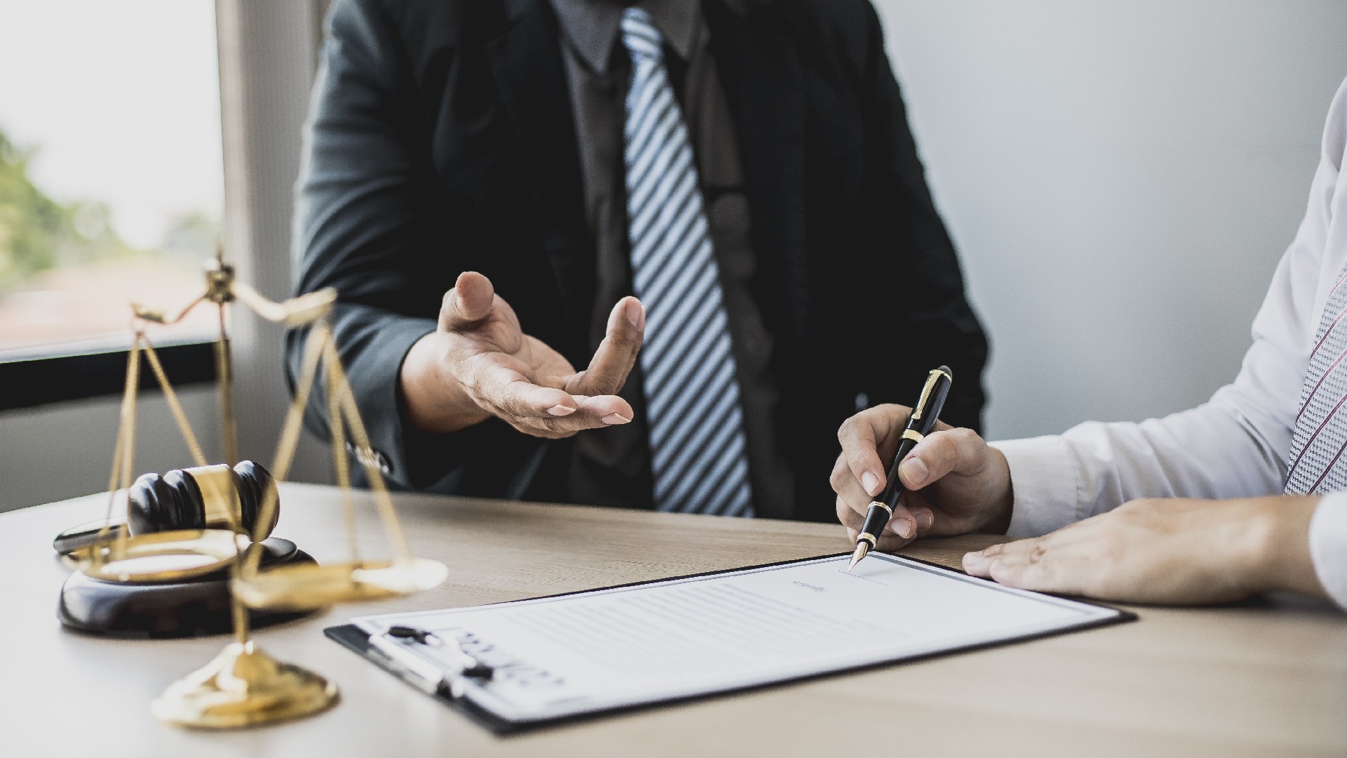 A lawyer speaks to a client about a contract