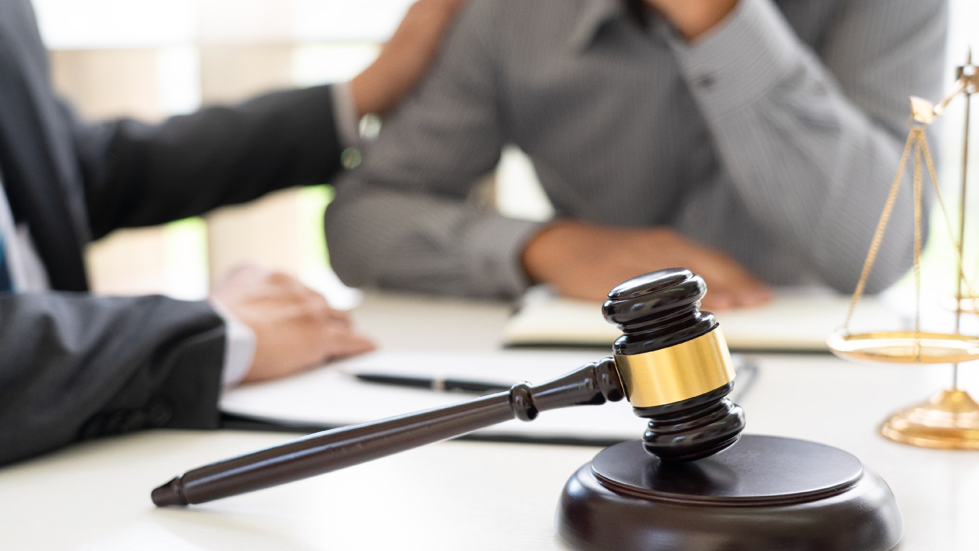 A lawyer touches a client’s shoulder to show how our Dallas credit repair lawyers are here for you