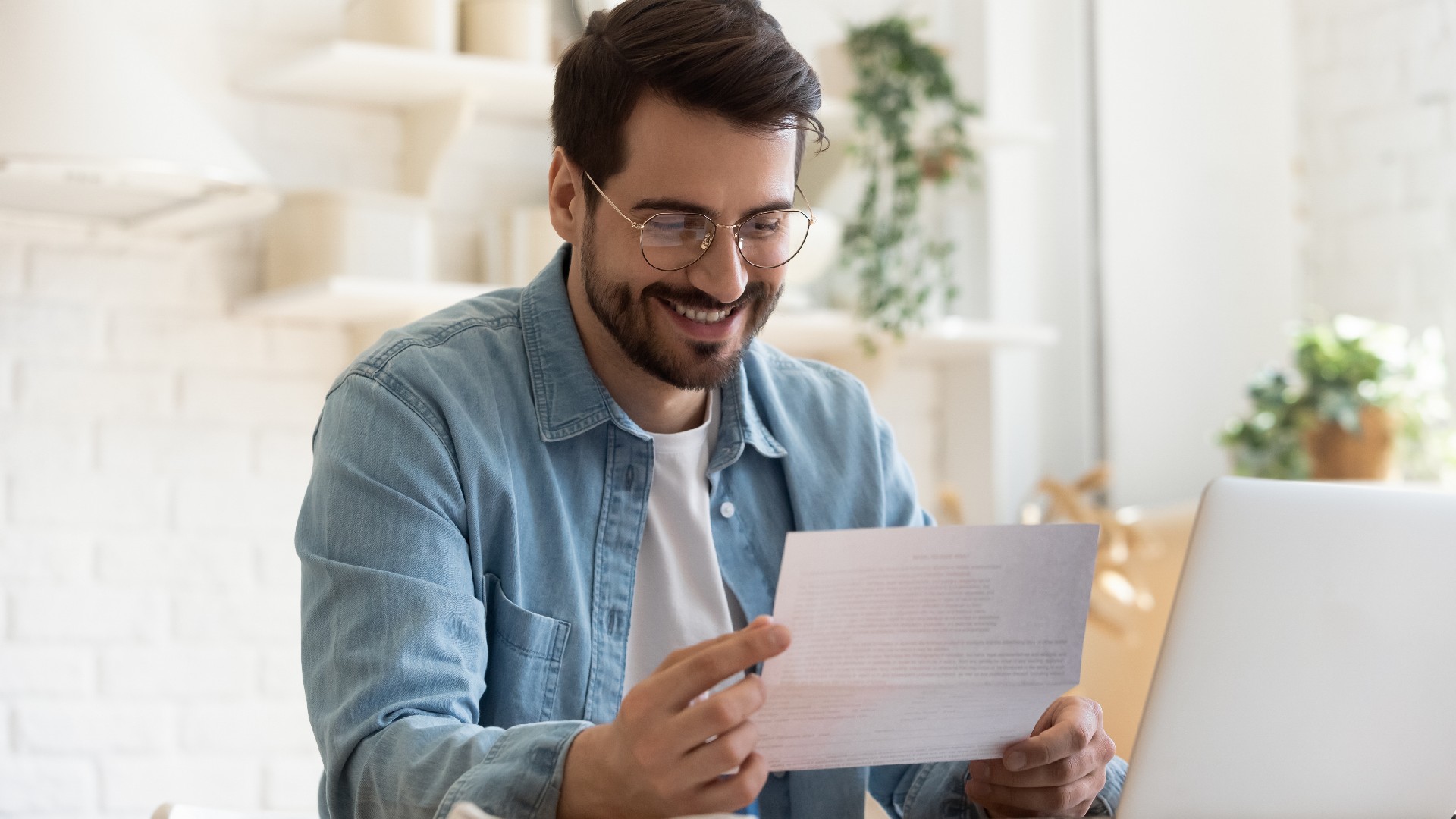 A man happily looks at paperwork