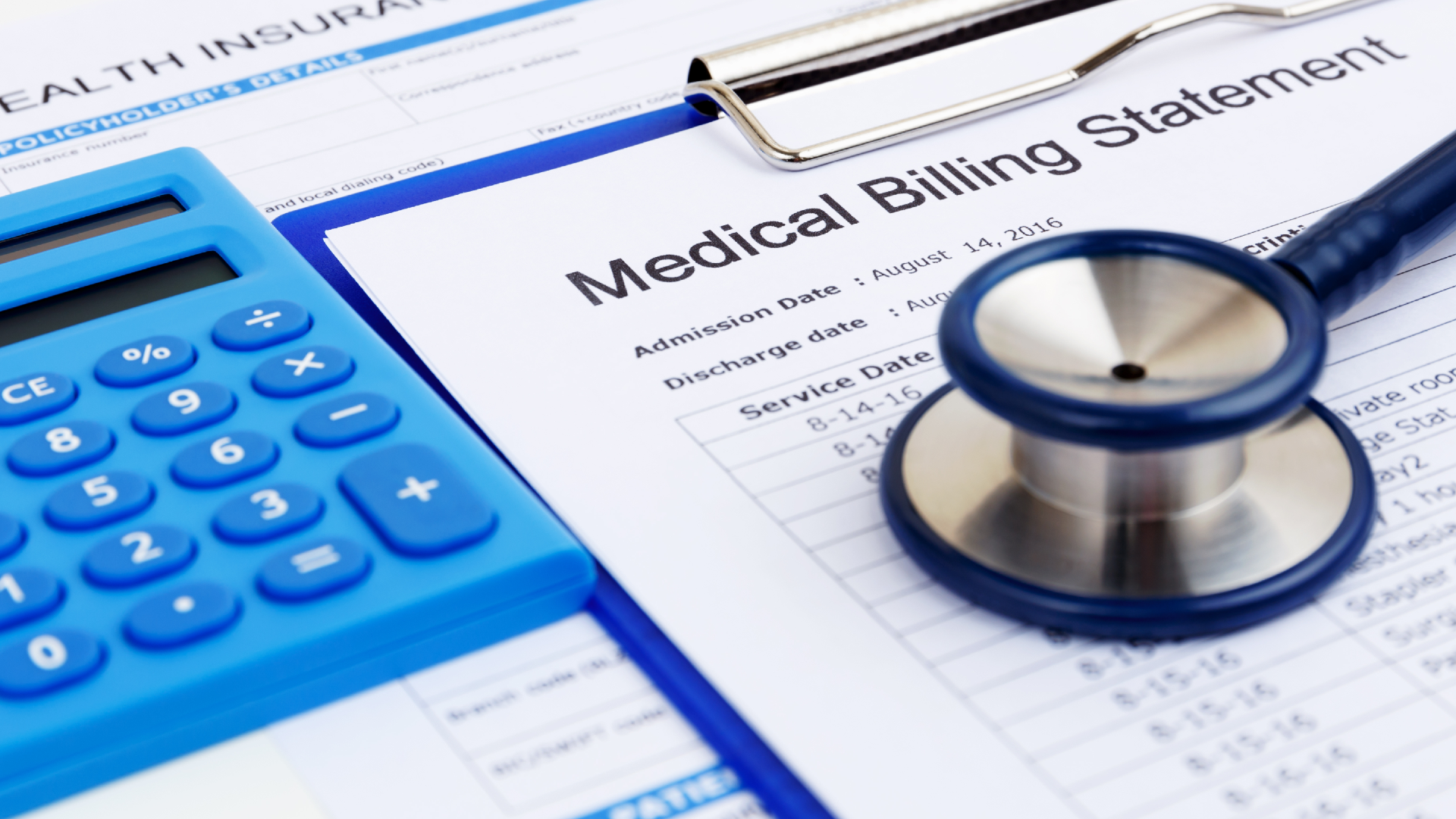 A medical billing statement near a stethoscope and a calculator