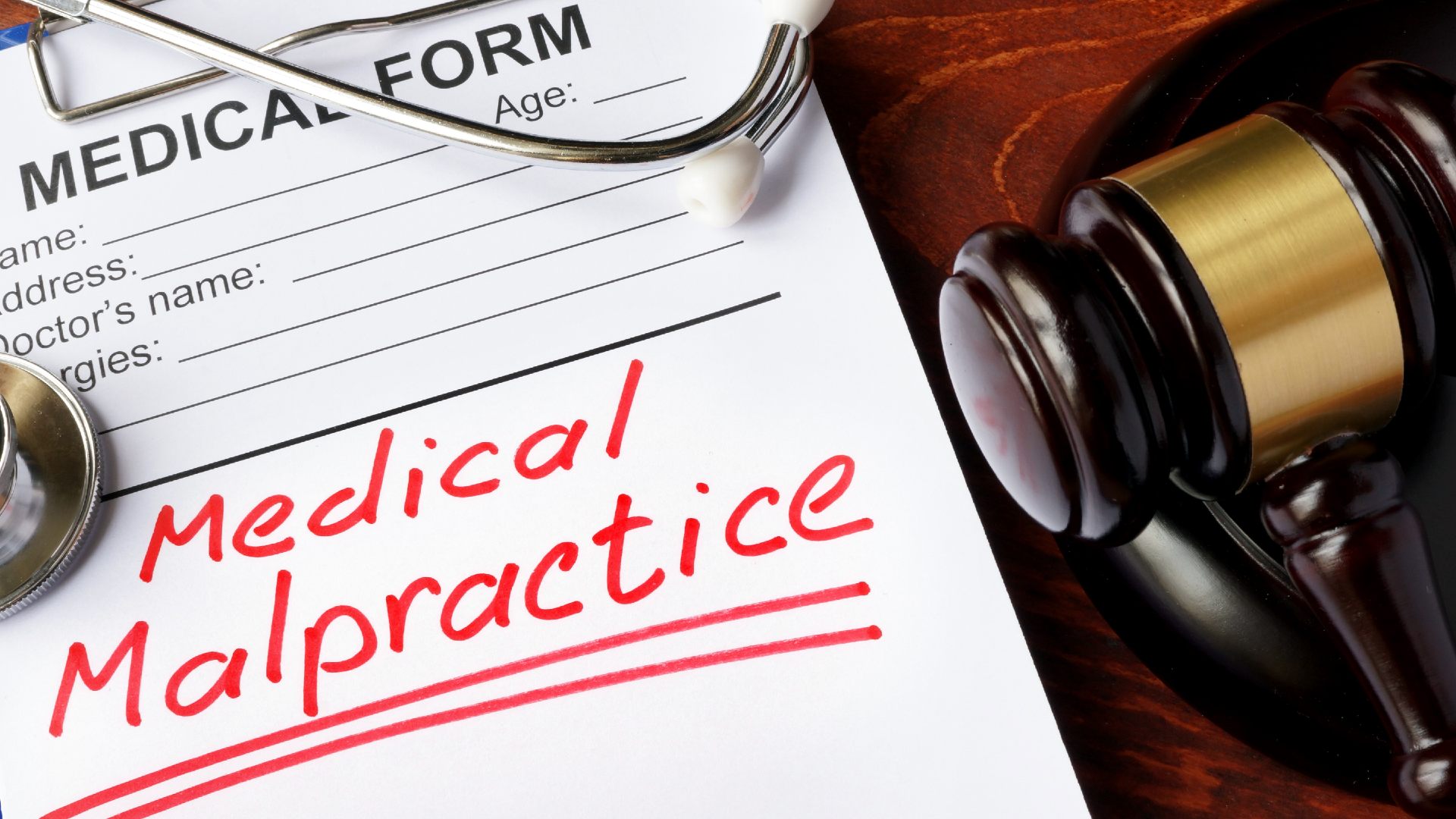 A medical malpractice form with a stethoscope and a gavel sitting on top