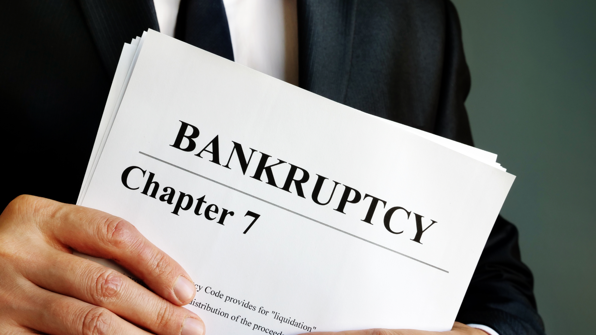 A person holding Chapter 7 bankruptcy paperwork