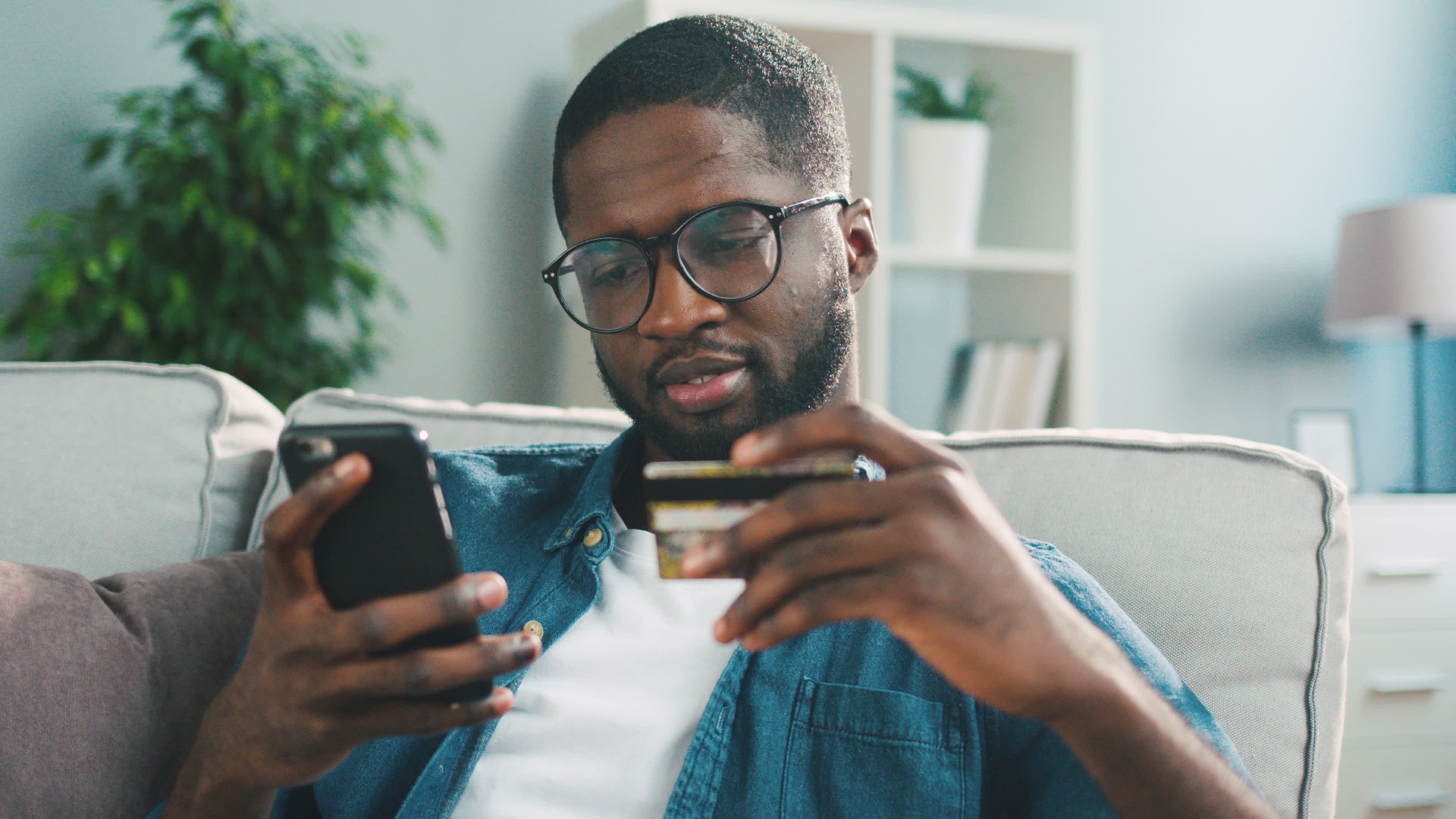 A person shops online with credit card via a mobile phone