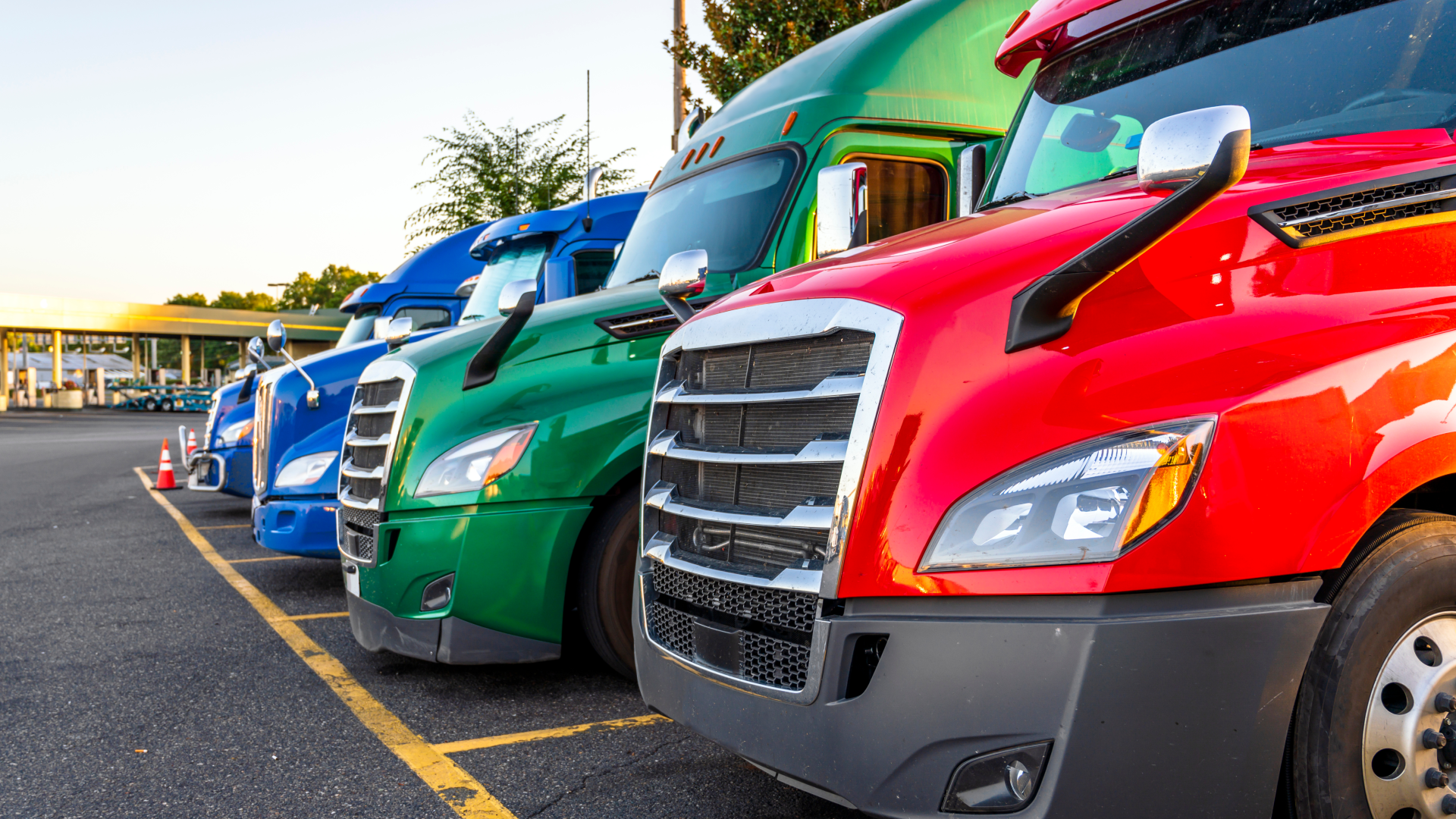 A row of different colored trucks in a parking lot