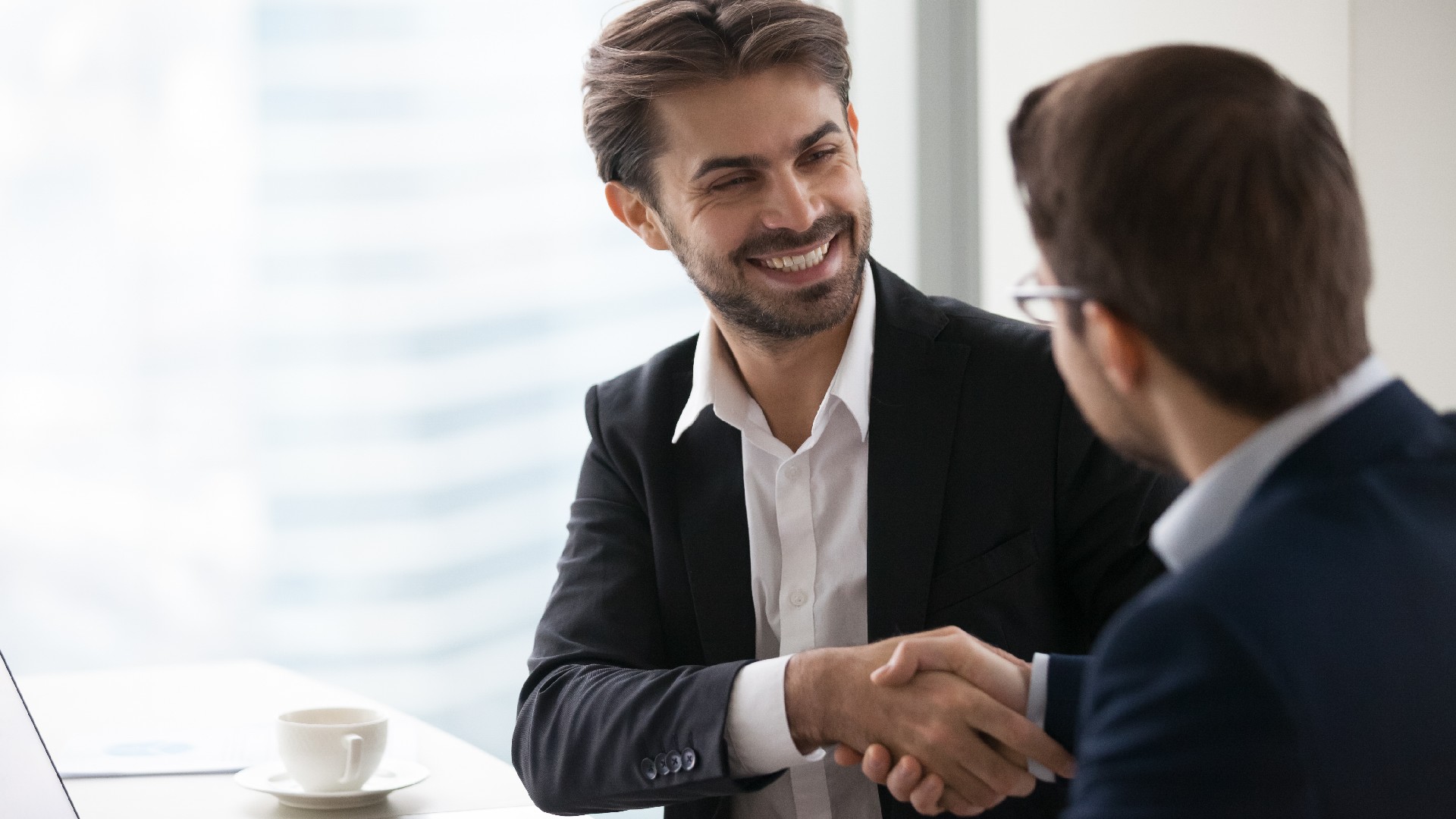 Two people shake hands