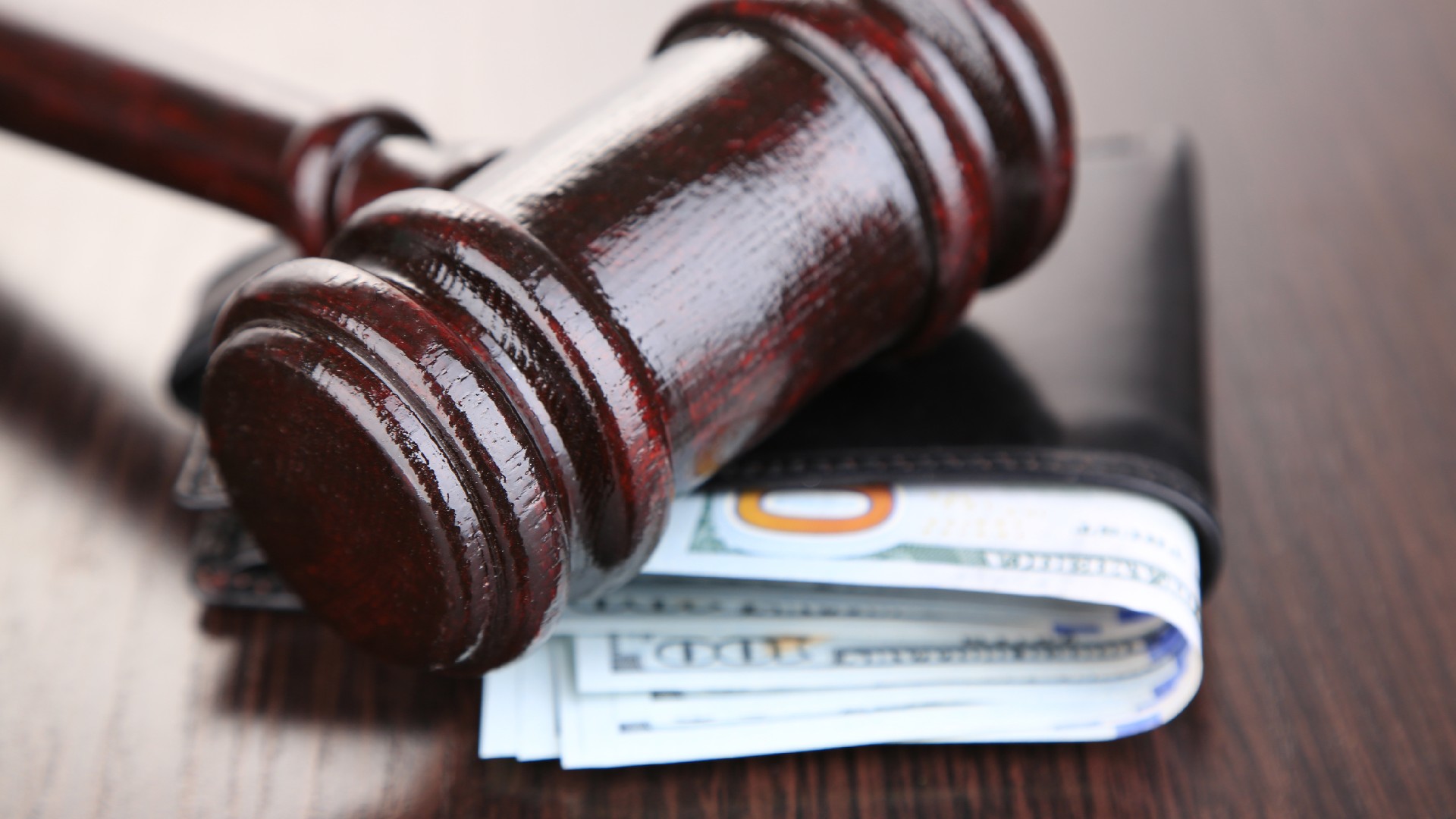 A gavel and money in wallet on a wooden background for Wage Garnishment Lawyers in Texas