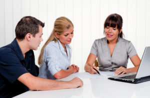 man and woman meeting with a female lawyer to discuss options