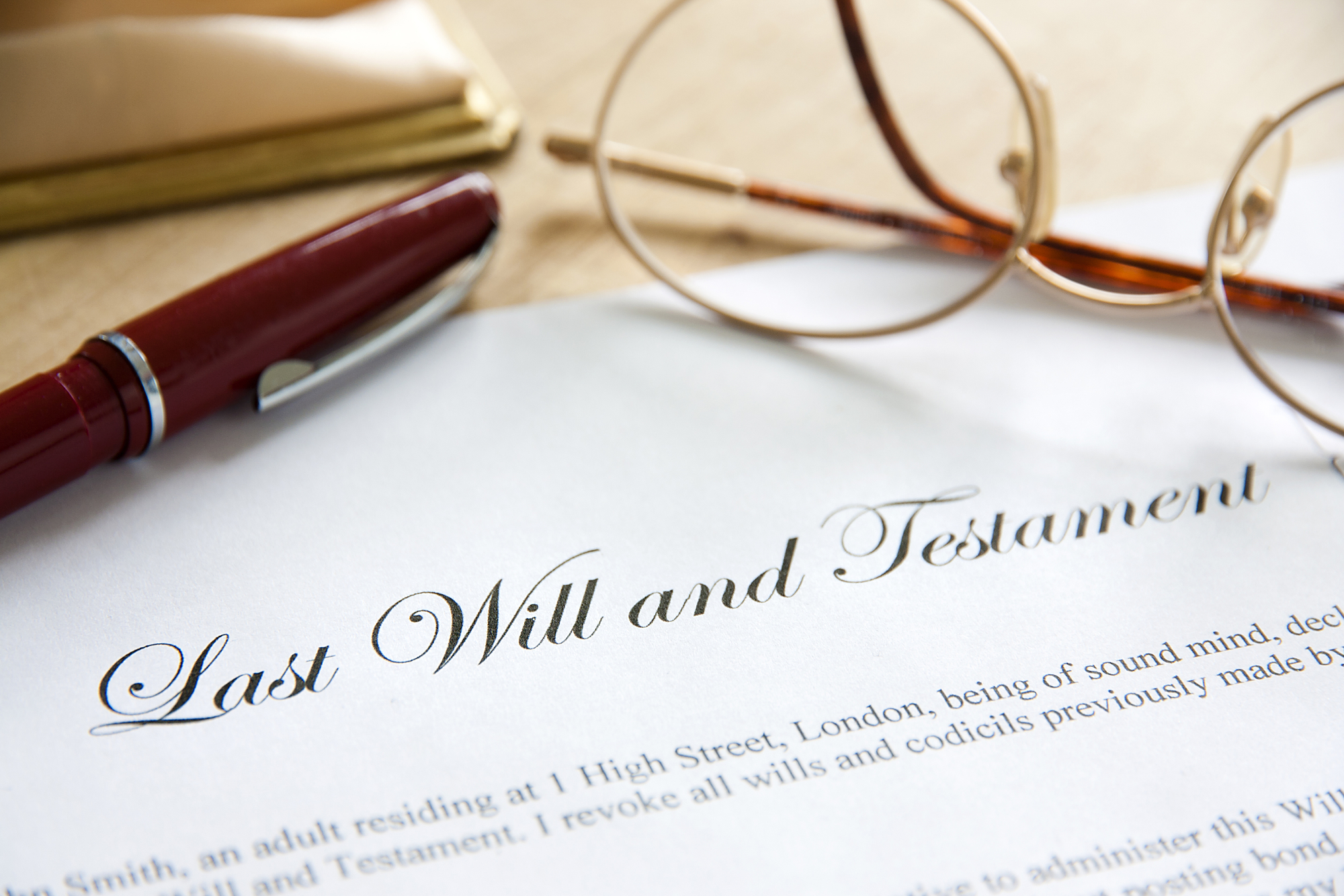 Probate Lawyer - Last Will and Testament concept image complete with spectacles and pen.