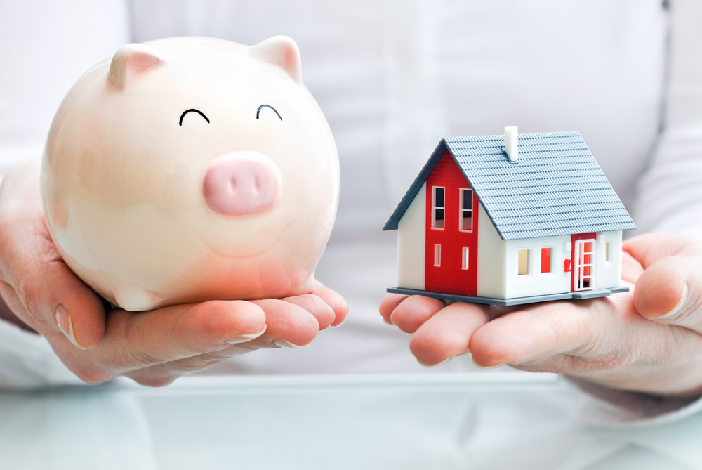 Why Estate Planning Is Necessary for Young People - Hands holding a piggy bank and a house model
